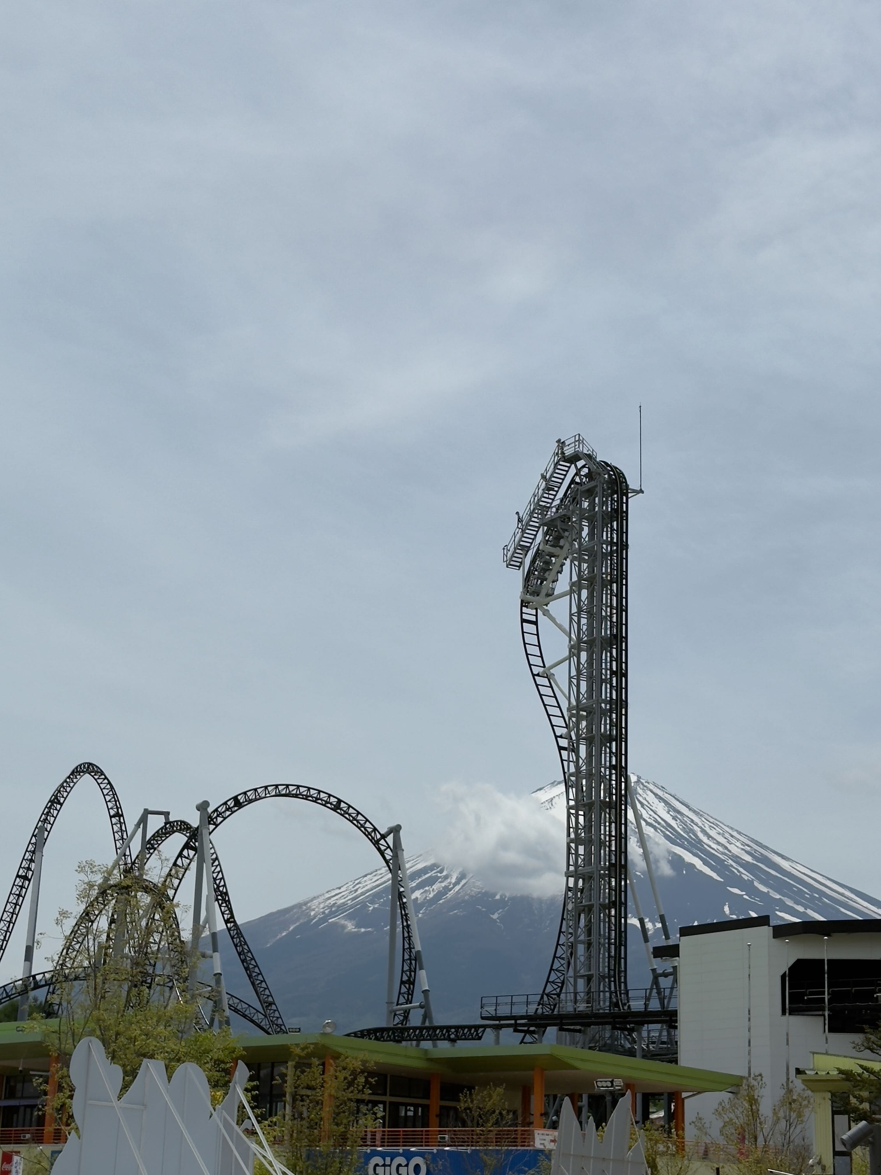 Fujiyama roller coaster at Fuji-Q Highland with Mt Fuji looming in the background, Japan